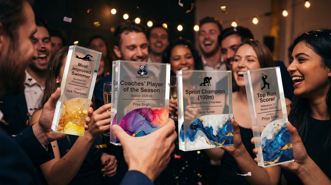 End-of-season sports awards dinner party showcasing proud athletes and teammates toasting with drinks and proudly displaying personalized recognition plaques under warm indoor bistro lighting.