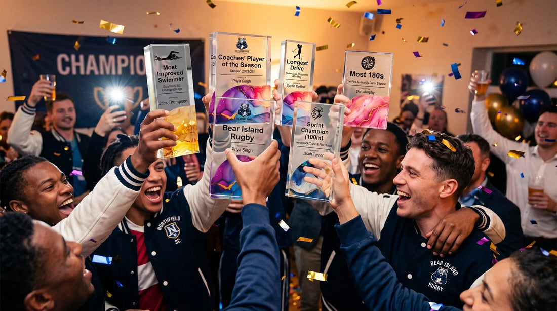 Bear Island Rugby team members raising custom crystal trophies to celebrate victory during an awards banquet.
