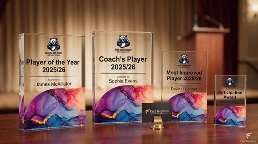 Personalised rugby trophies for UK clubs featuring Player of the Year, Coach’s Player, Most Improved Player and Participation Awards with custom names and 2025/26 season details.