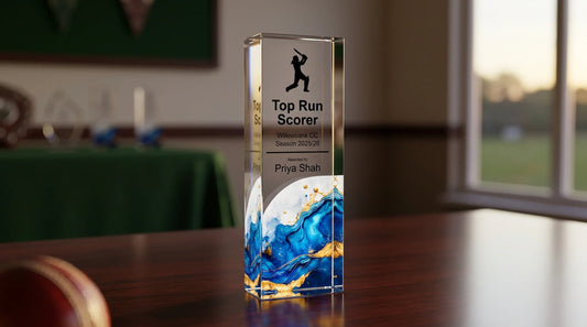 Personalised cricket trophy UK showing a crystal-clear acrylic block award engraved with Top Run Scorer for Willowbank CC Season 2025/26, awarded to Priya Shah, with a cricket batsman silhouette and blue gold marble design