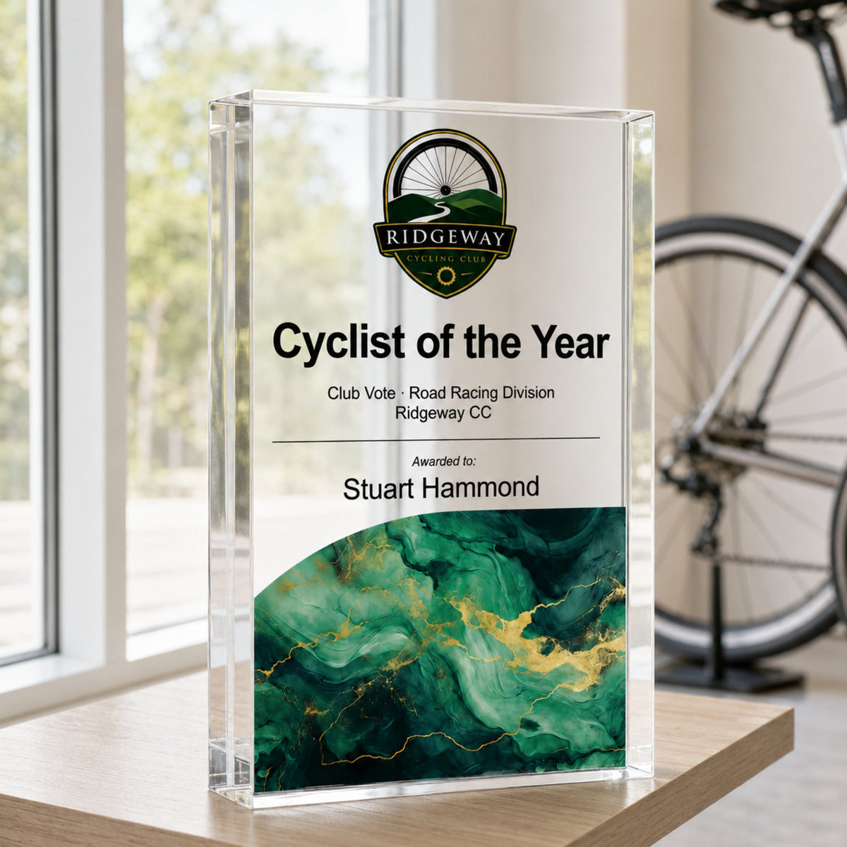 Cyclist of the Year acrylic trophy with a cycling club crest and green base