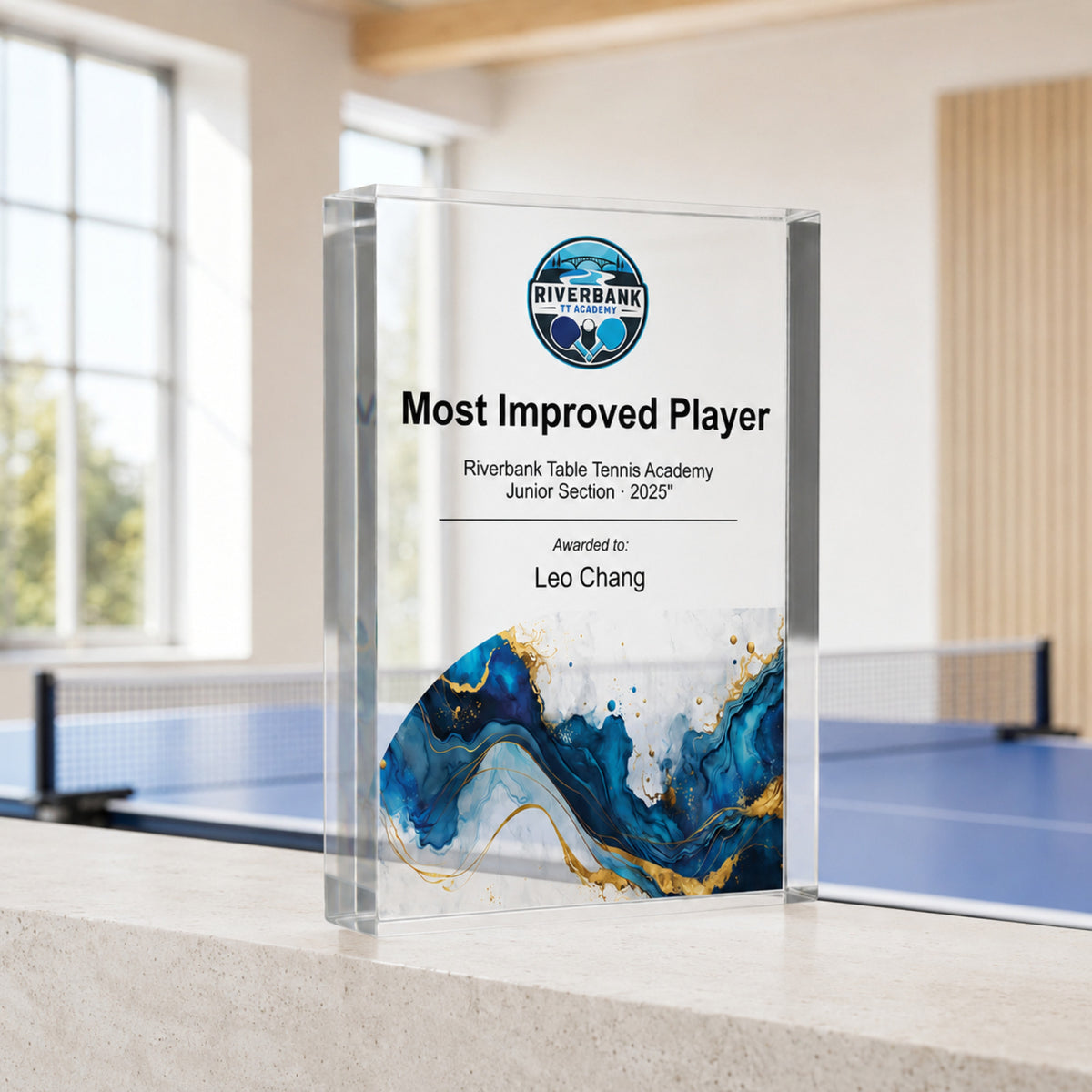 Most Improved Player table tennis trophy with an academy crest and blue base