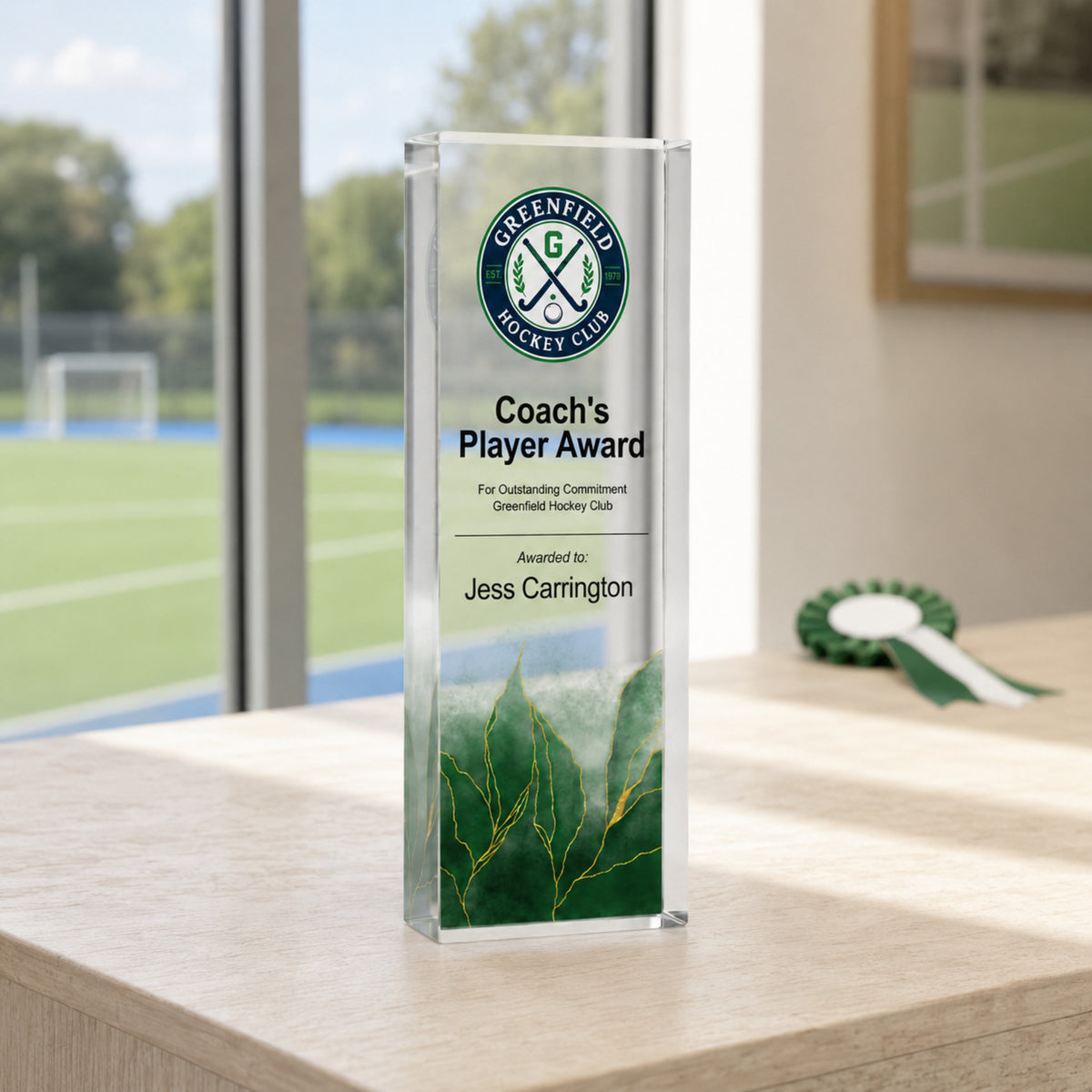 Slim upright Coach's Player Award hockey trophy with a school crest