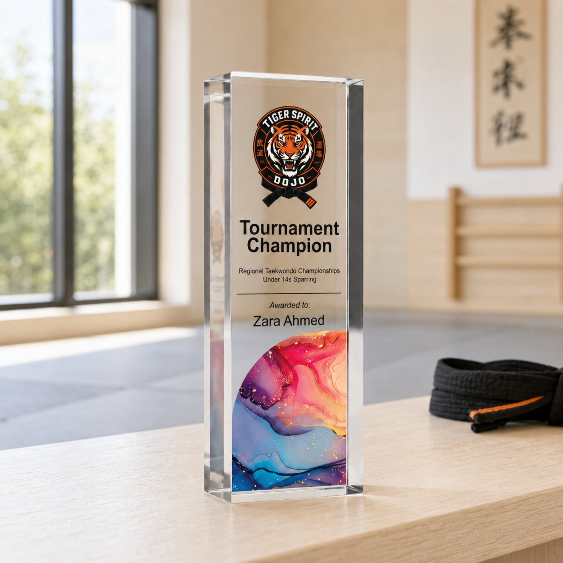 Slim upright martial arts trophy printed with an academy crest for a tournament champion