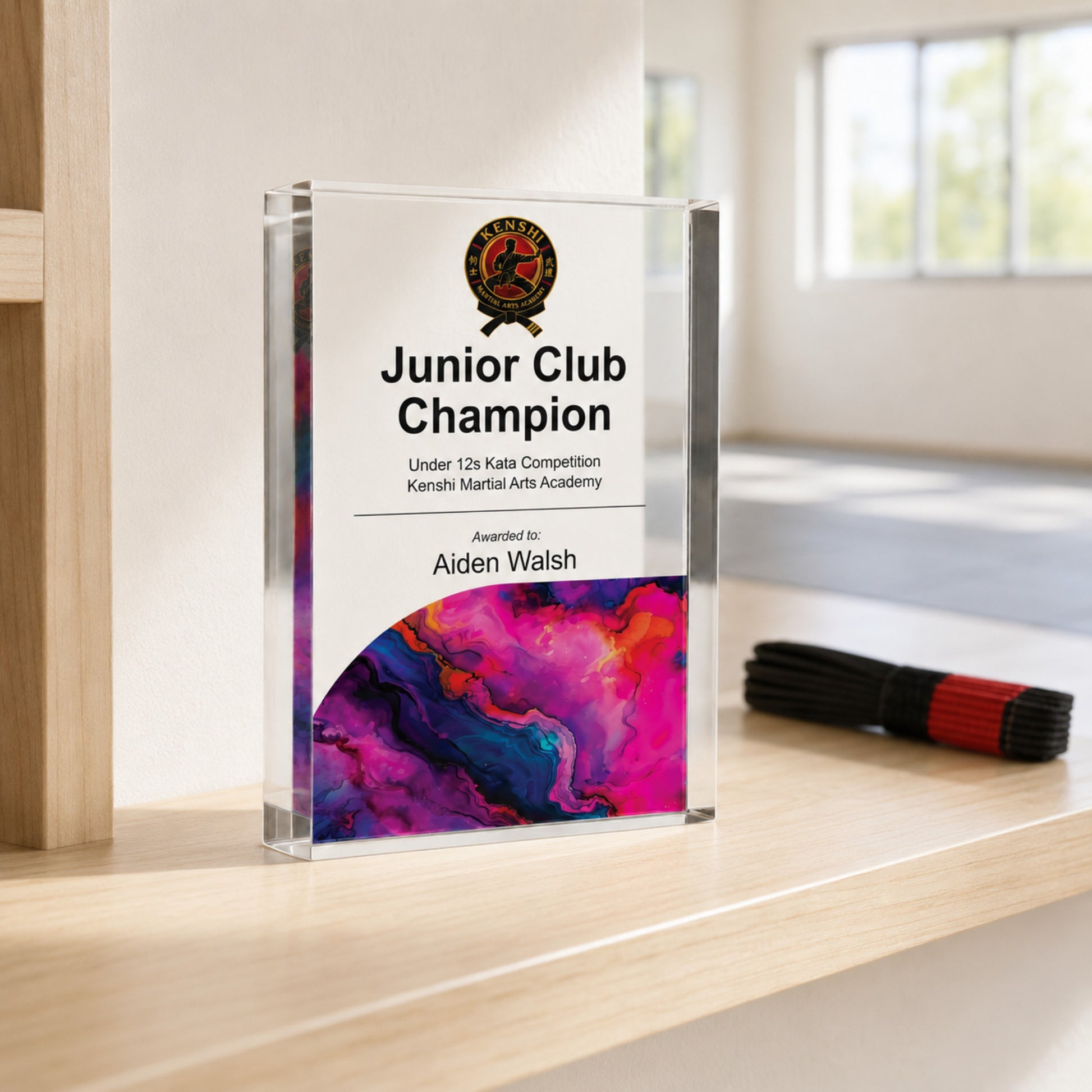 Junior Club Champion martial arts trophy with an academy crest for a youth grading
